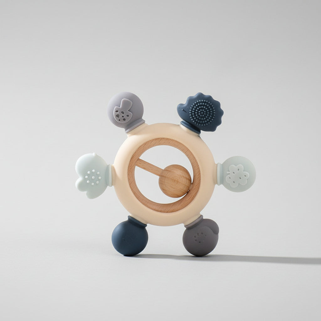 MimiAnneau™ silicone and wood baby teething ring with textured sensory nodes in blue and grey tones.