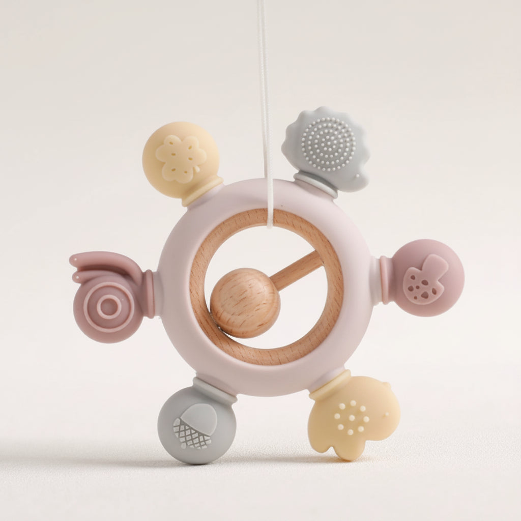 MimiAnneau silicone and wood baby teething ring in pastel colors.